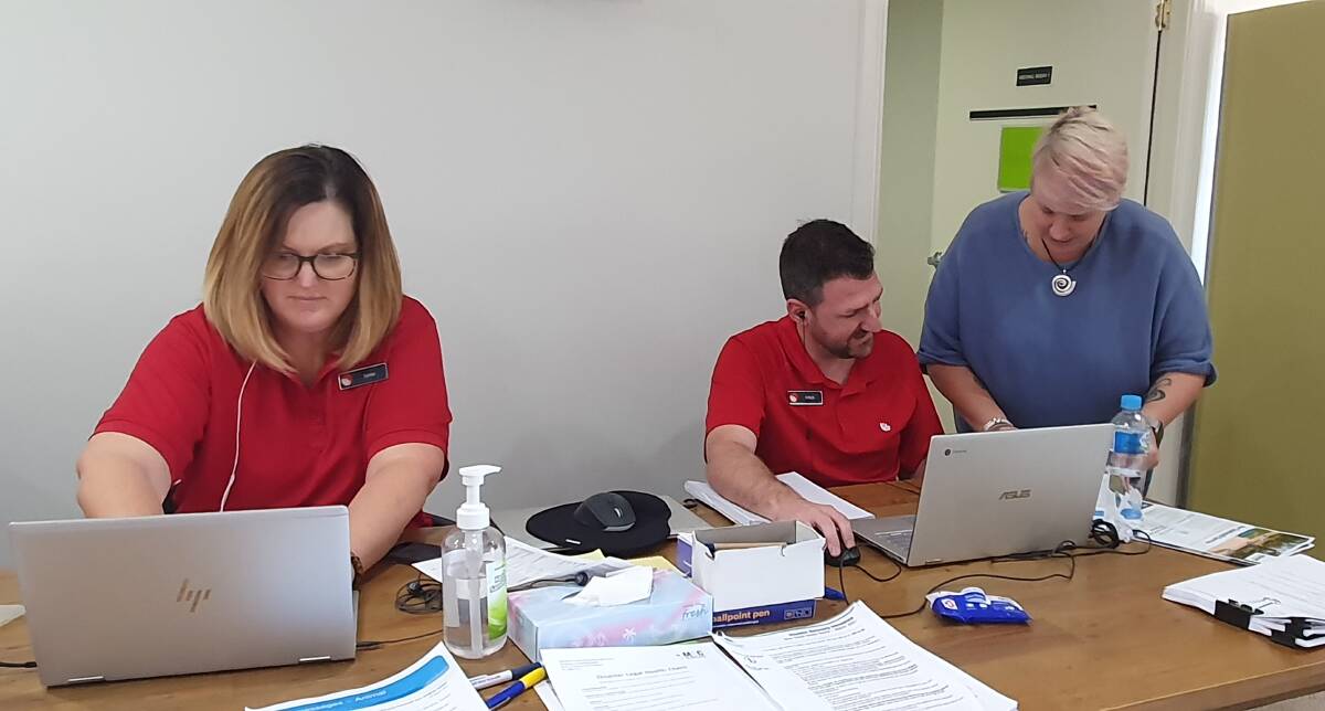 Information point: Lena Jones and Mitch Worth from Service NSW, along with council's Lucilla Marshall, are among those on hand to help residents at the Port Macquarie flood outreach centre.