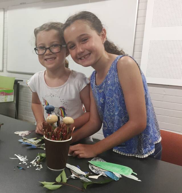 School holiday fun: Sisters Lucy and Adelaide Kennedy from Newcastle enjoy the workshop at Sea Acres Rainforest Centre.