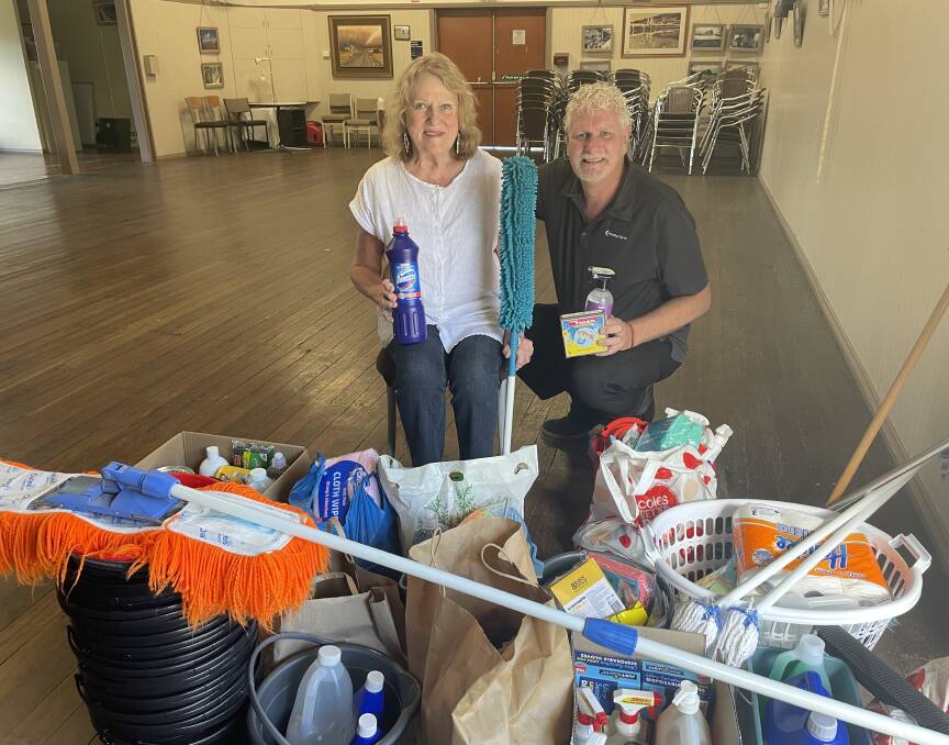 Telegraph Point Community Association president Sue Pike and Hastings Co-op business and community development manager Tim Walker gather together the donations from the Telegraph Point community.