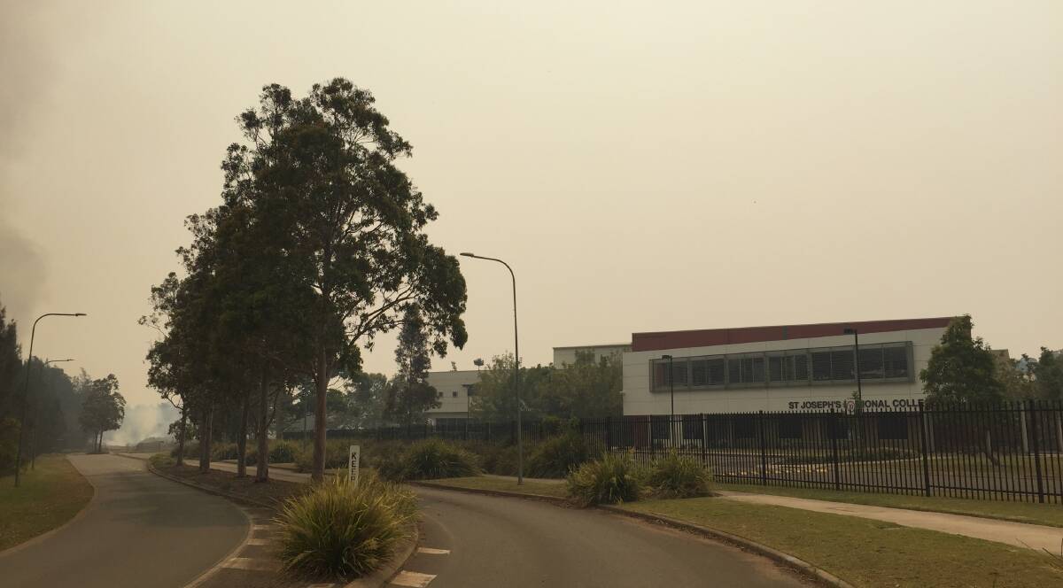 Smoky conditions: Smoke is thick in the air at St Joseph's Regional College.