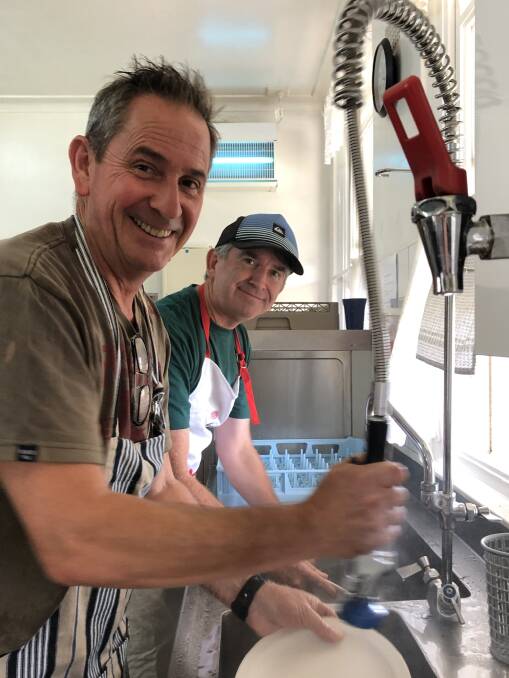 Team effort: Steve Newman and Michael Jones wash dishes at the Port Anglican Soup Kitchen.