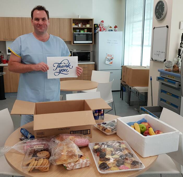 Grateful: Port Macquarie Base Hospital registered nurse Ty Mitchell says thank you for the donated snacks.