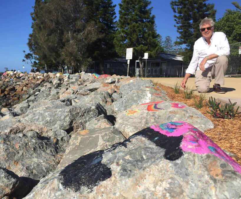 Prime public space: Cr Geoff Hawkins promotes the council's ban on the painting of rocks on the Town Green foreshore, west of the breakwall.