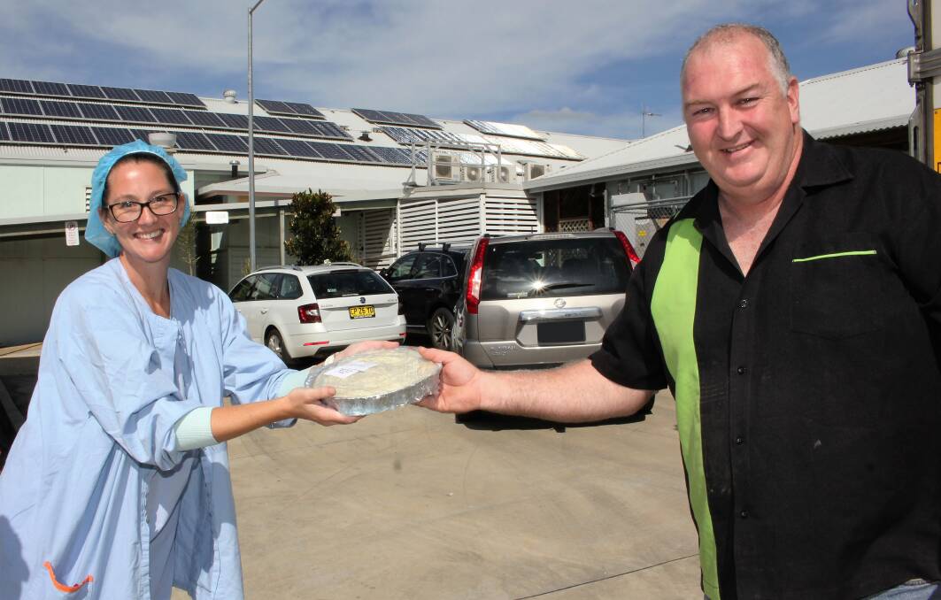Thank you: Wauchope District Memorial Hospital perioperative nurse Kristin Matthews collects a meal for her family from Craig Freudenstein of XS Food, while practising great social distancing skills. Photo: supplied