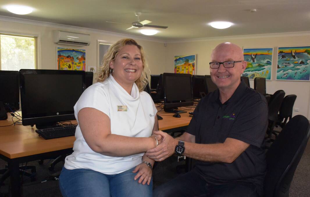 Helping hand: St George Bank Port Macquarie branch manager Karen Hales is thanked for the donation by Endeavour Mental Health Recovery Clubhouse chief executive officer Rob Moorehead.