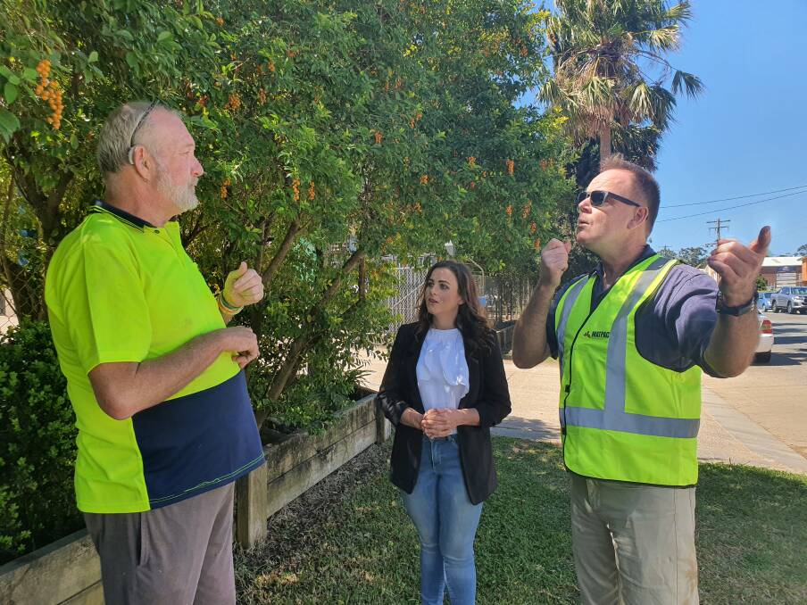 Professional role: Andrew Pooley (right) puts his sign language interpreting skills into action during a conversation with Peter Goddard, who communicates in Auslan, and Aus Blue Bins operations manager Erin Matthews.