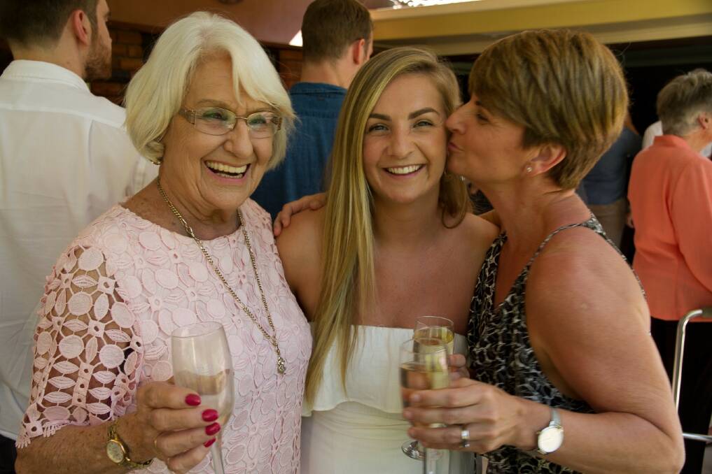 Betty Allman surrounded by loved ones at her granddaughter's wedding.