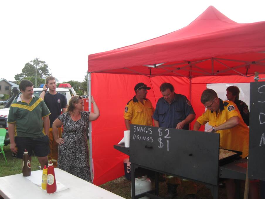 Community focus: North Shore Rural Fire Brigade raises funds during Christmas carols with the Big Red Bus at Kangaroo Park. Photo: Northside Progress Association