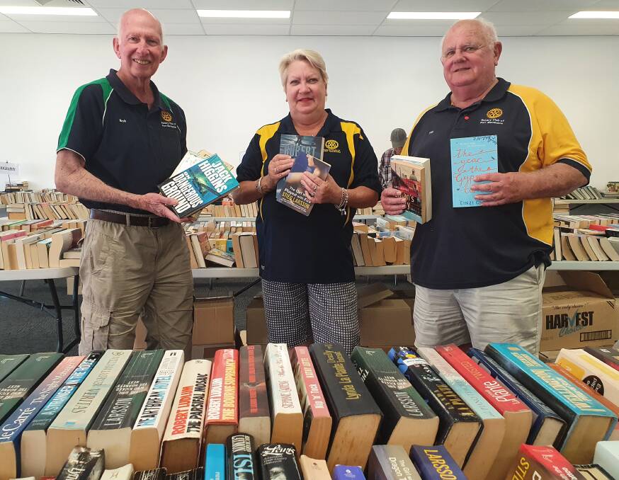 Team effort: Rotary Club of Port Macquarie book sale coordinator Bob Cleland, president Elizabeth Fielding and community service director Phil Perry volunteer at the Spring Book Sale.