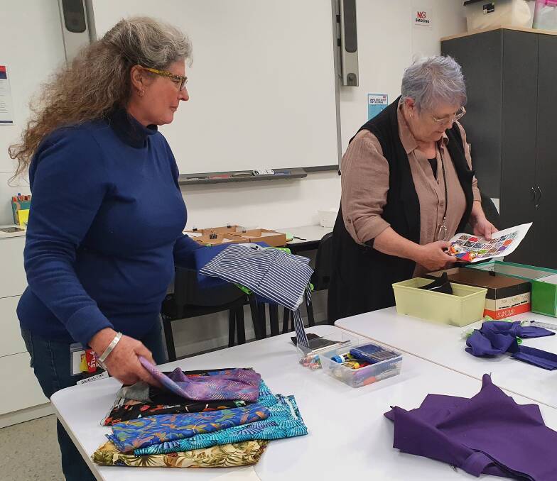 Busy time: Volunteer and trainer Sandra Marson and MakerSpace manager Sue English work on the face mask project.