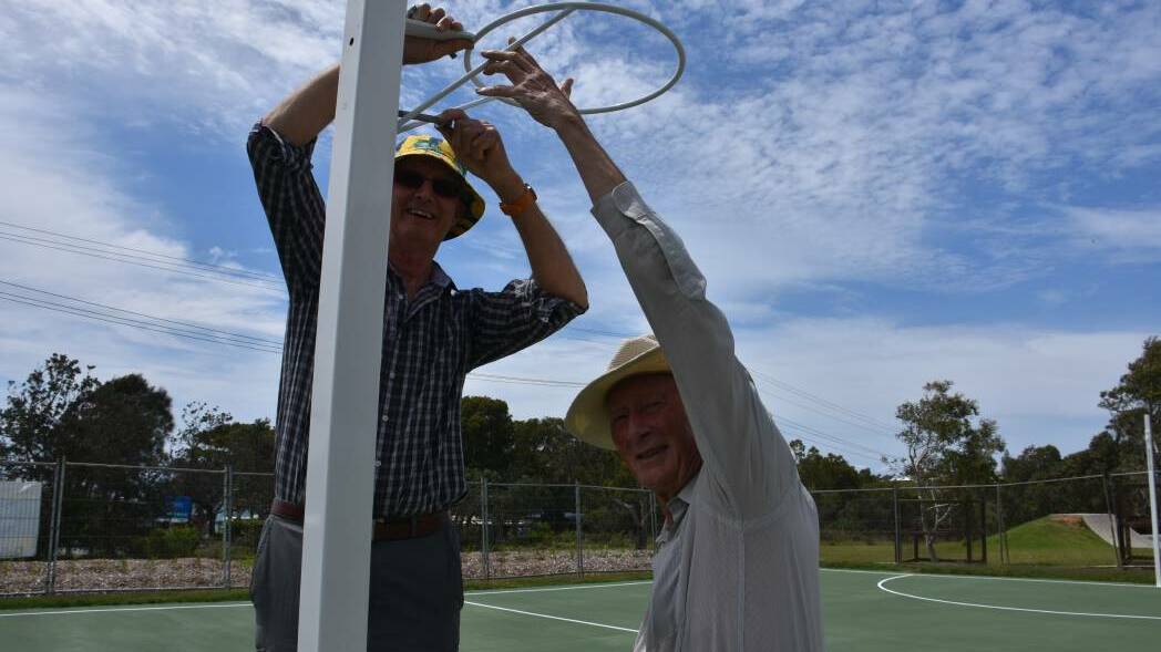 Bonny Hills Progress Association president Roger Barlow and Ian Simpson work on putting a netball hoop up. Roger Barlow is the 2019 Senior Citizen of the Year.