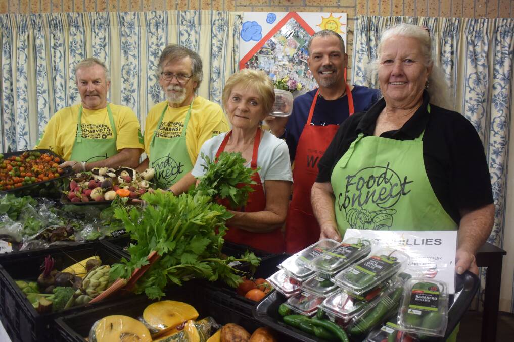 Helping others: Matthew Giles, Arthur Griffiths, Carol Kendall, Jeff Forster and Julz Nash-Smith get the food ready in preparation for Port Macquarie Neighbourhood Centre's Food Connect program.