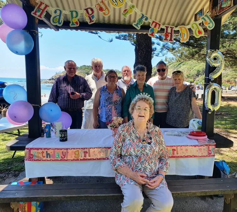 Many happy returns: Patricia White celebrates her 90th birthday at Shelly Beach surrounded by Port Macquarie Hastings U3A Photography Group members Brian Tolagson, Graham Martin, Alex McCormack, Dave Curry, Joanne Hogan, Barry Byrne and Sue Maguire