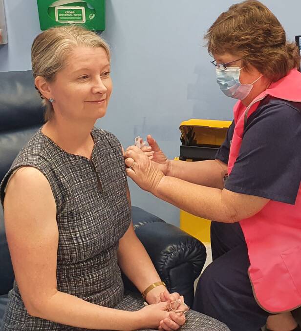 First in line: Marj Bolton (right) gives infectious diseases specialist Dr Aiveen Bannan her first dose of the AstraZenica vaccine at Port Macquarie Base Hospital in late March.