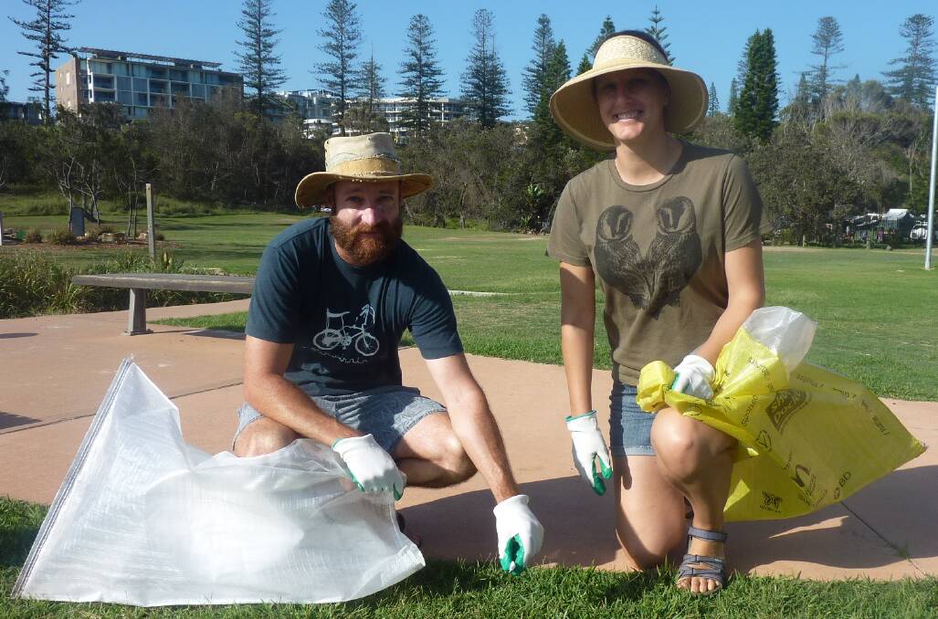 Will Steggall and Rachael Wells collect litter from the Town Beach area.
