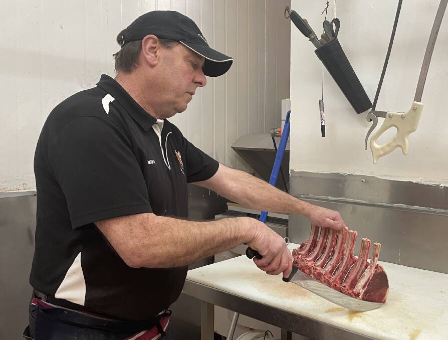 Colonial Quality Meats owner Marty Archer prepares a standing rib roast for sale. Picture by Lisa Tisdell