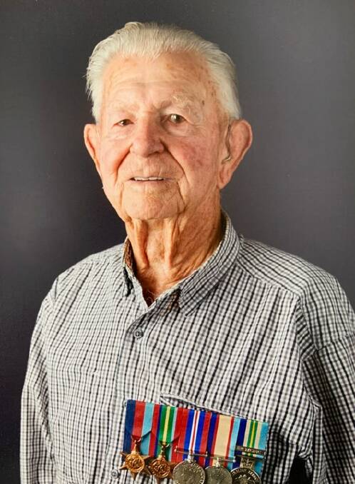 Bill Alcock, who served in Borneo during World War II, with his army medals.