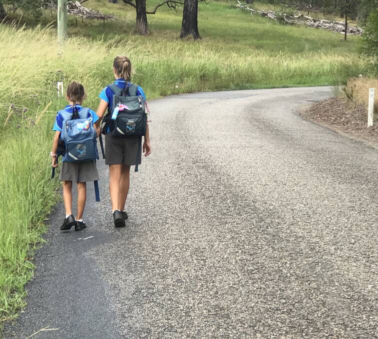 Narrow road: Bianca and Sarah King walk along Fernbank Creek Road.