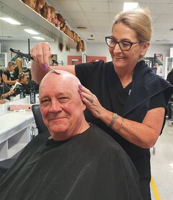 Fundraiser: TAFE NSW hairdressing teacher Deb Powell puts the finishing touches on Mark Sloane's new look thanks to the World's Greatest Shave.