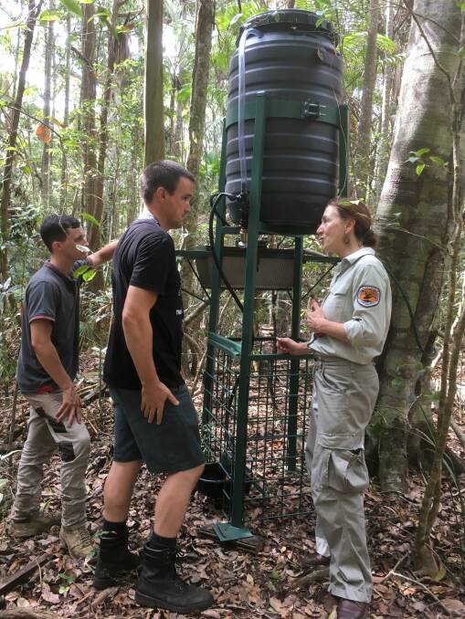 Working together: Port Macquarie Koala Hospital volunteers Jeremy Bear and Nic Snell and NPWS staff member and FAWNA carer Le Arne Le Vielle discuss the benefits of the wildlife drinking station at Sea Acres.