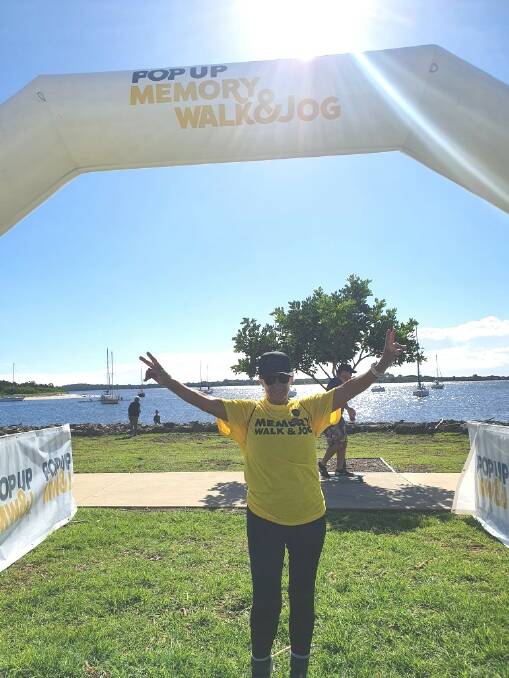 Nikki Bawden crosses the Port Macquarie Memory Walk and Jog finish line.