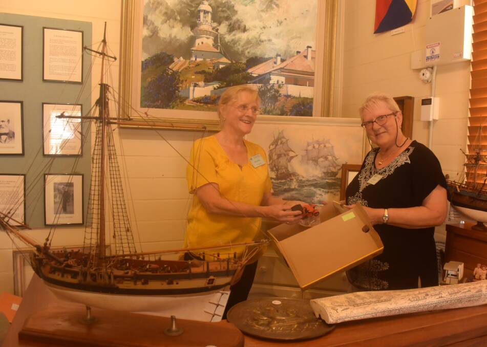 Mid North Coast Maritime Museum watchkeepers Suzanne Montgomery and Ingrid Kennewell prepare for the museum's stall on Australia Day.