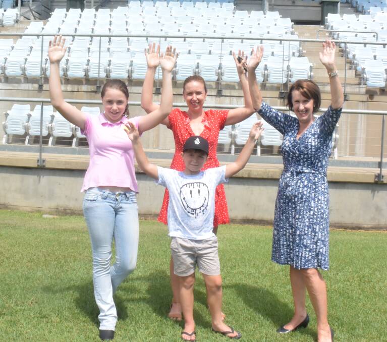 Family focus: Charlie Treasure (front), his sister Lucy and mother Sam, and Port Macquarie MP Leslie Williams, encourage families to take part in the Active Kids and Creative Kids programs.
