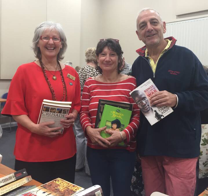 Page-turning event: Marketing and programs librarian Kate Forrest and Riverside Drive street library representatives Anne Mangeant and Jacques Bernard enjoy the Big Book Swap.