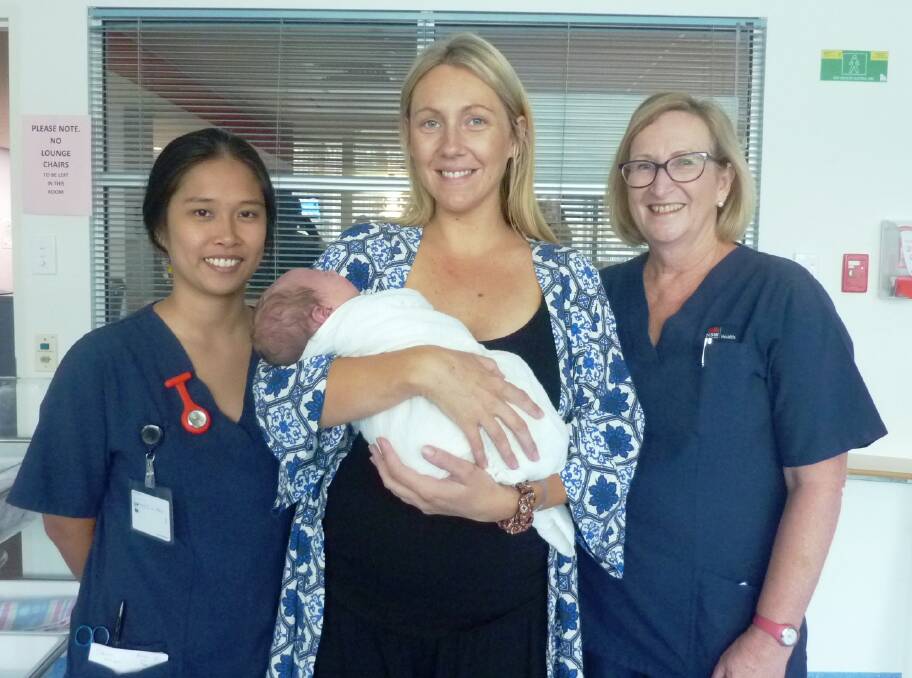 Rewarding career: Port Macquarie Base Hospital midwives Arlene Lavilla (left) and Cathy Foley (right) with Allison Gwilliam and her newborn Reef Cameron.