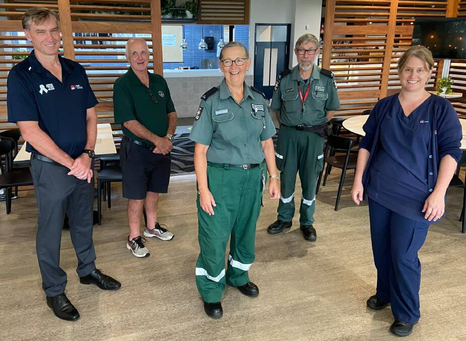 Mid North Coast Local Health District chief executive Stewart Dowrick, Port Macquarie Golf Club president Bill MacDonald, George and Elizabeth Driussi from St John Ambulance NSW and Mid North Coast Local Health District clinical nurse specialist Kellie Frost gather at the evacuation centre at the golf club.