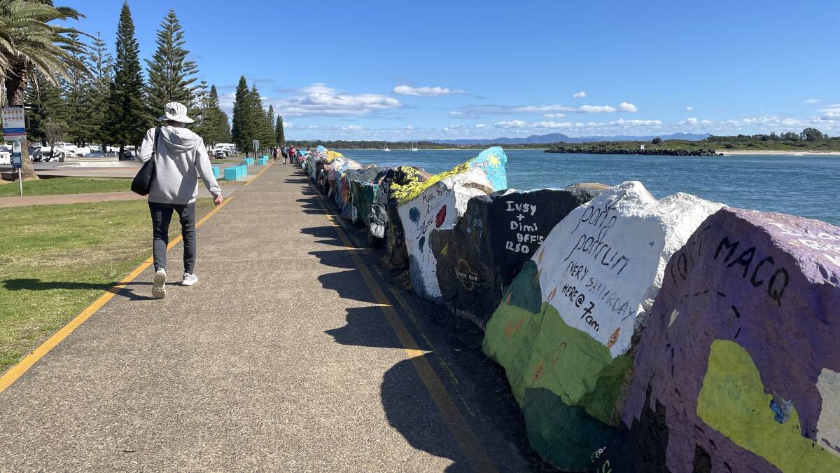 Colourful painted rocks along the breakwall contain tributes, messages and memories from tourists and residents. Picture by Lisa Tisdell