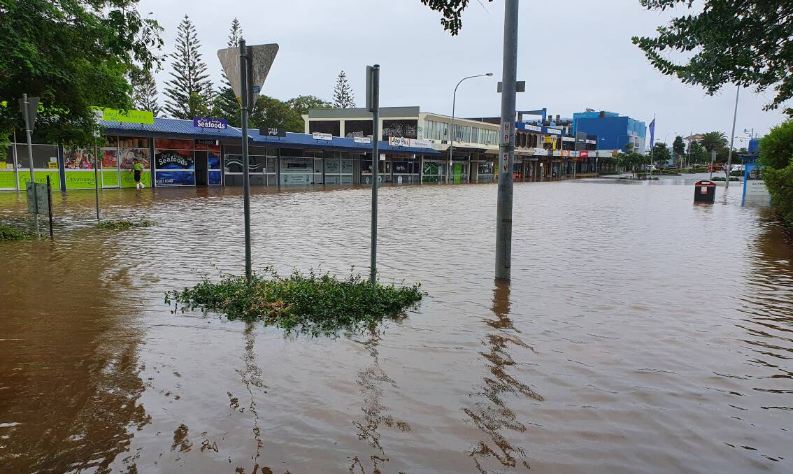 Impacted: Floodwater remains in Port Macquarie's Short Street on Monday.