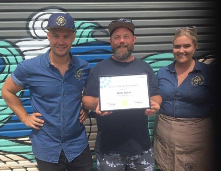 Generous support: Dan Hunter, Lee Wood and Hollie Ford from Hello Sailor pictured with a certificate from Lifeline in recognition of the venue's support.