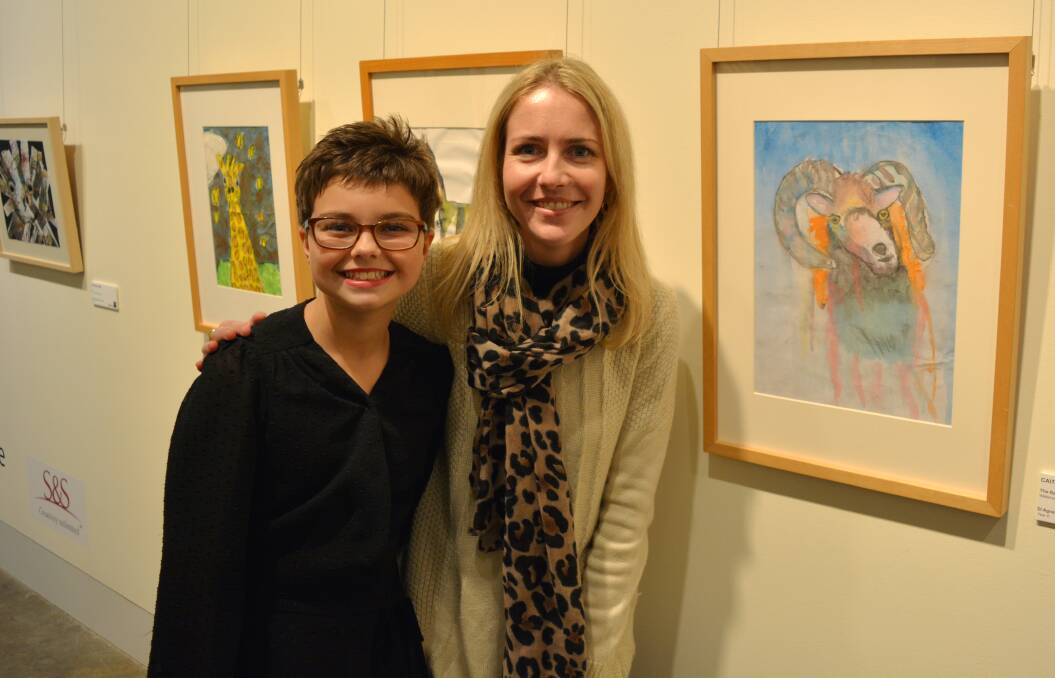 Creative expression: Caitlyn Toomey from St Agnes’ Primary School and Jane Whitfield from Drawn to Art view Caitlyn's artwork in the exhibition.