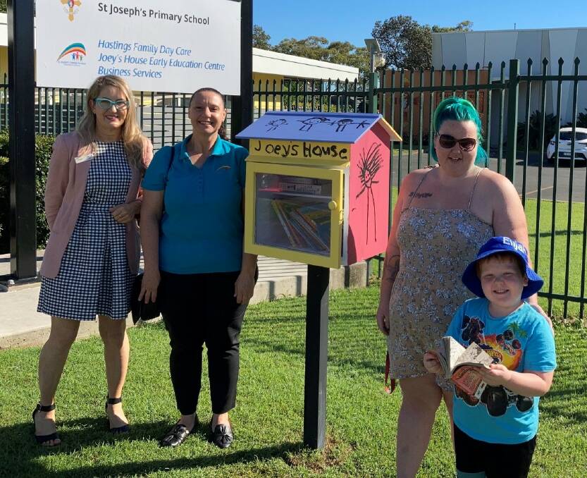 Marketing and outreach librarian Angie Hazelton-Kelly, early childhood teacher Josie Loiacono, and Tara Fuller and her son Elijah launch the Joey's House Early Education Centre street library. 