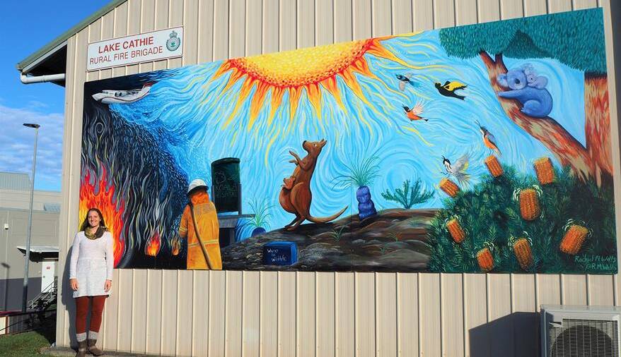 Community resilience: Artist Rachel Wells pictured with a gratitude mural on the Lake Cathie Rural Fire Service building.