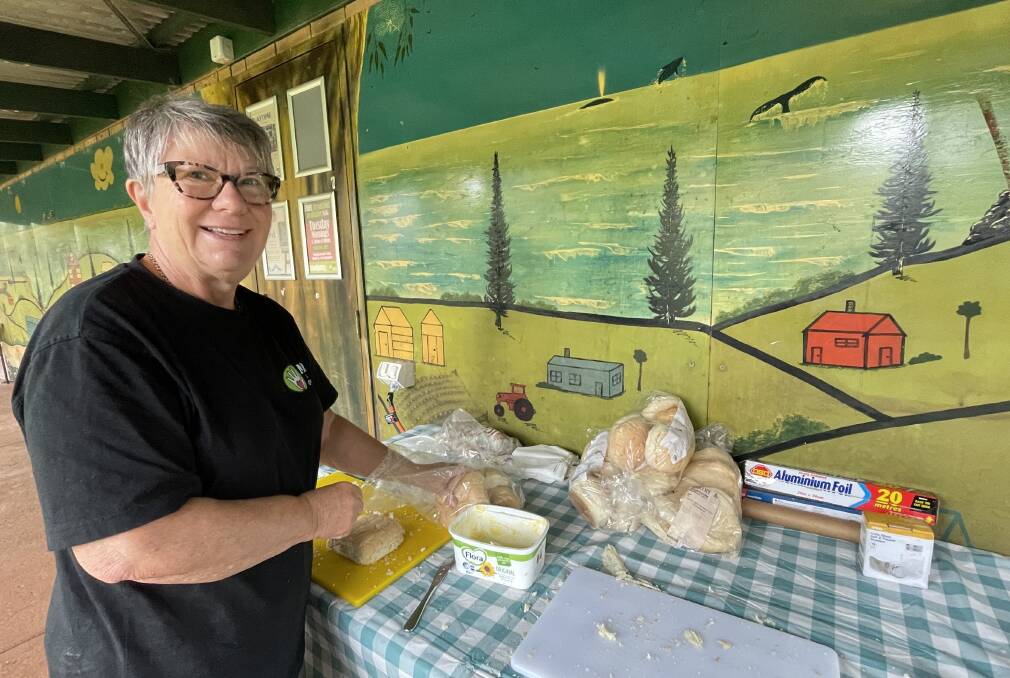 Volunteer Liz Condon butters bread rolls during the mobile food van's shift at the Port Macquarie Neighbourhood Centre. Picture by Lisa Tisdell
