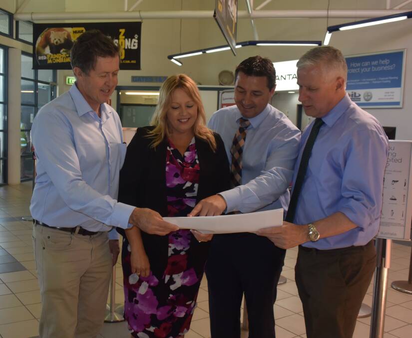 Cowper MP Luke Hartsuyker, mayor Peta Pinson, The Nationals candidate for Cowper Patrick Conaghan and Deputy Prime Minister Michael McCormack look over the airport terminal building upgrade plans.