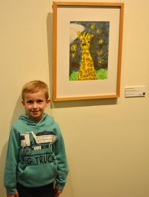 Jake Whitfield pictured with his artwork titled "My Giraffe in the Starry Sky."