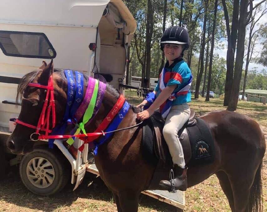 Zoe Lawrence is proud of her pony club ribbons. Photo: Port Macquarie Pony Club