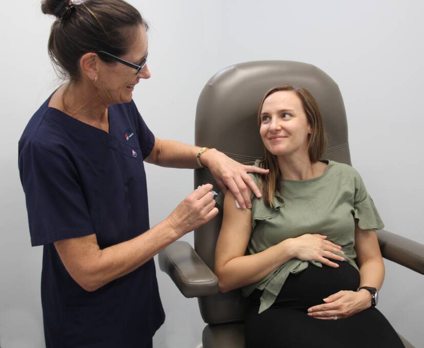  Health matters: Nurse Patricia Somers gives expectant mum Kylie Bigeni her flu shot. 