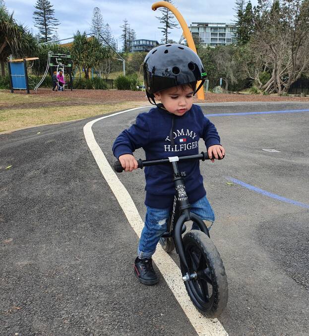 Outdoors adventure: Rudy Baker rides his bike on the scooter pump track at Town Beach playground.