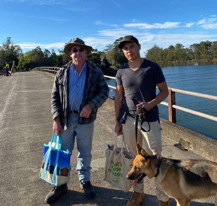 On foot: Matthew Rourke and George Freeman, with his dog Luna, prepare to walk across Rawdon Island bridge.