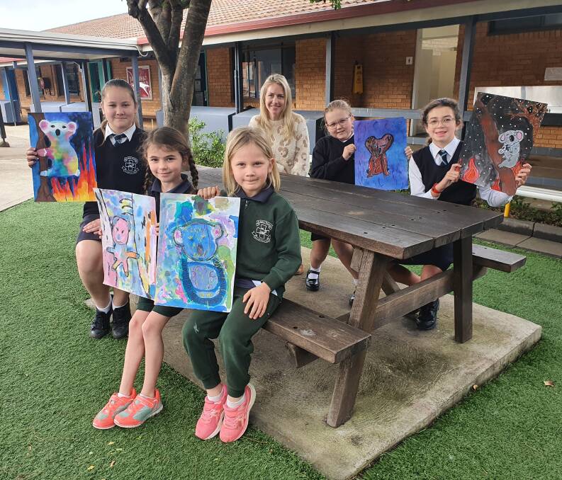 Meaningful artworks: Jane Whitfield from Drawn to Art (back left) looks on as (front) Emma Galafassi-Barnes, Maisie Prosser, Asha Walker, (back) Montana Newell and Maya Perry display their artworks bound for Port Macquarie Koala Hospital.