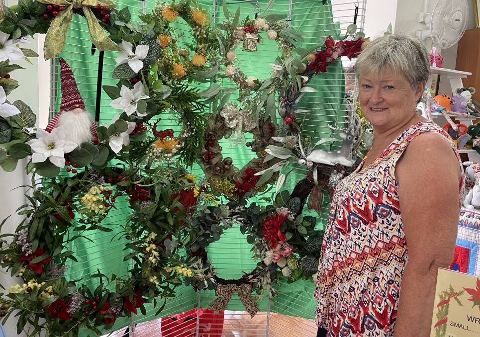 Robyn Hall sells Christmas wreaths and decorations at the CWA market.