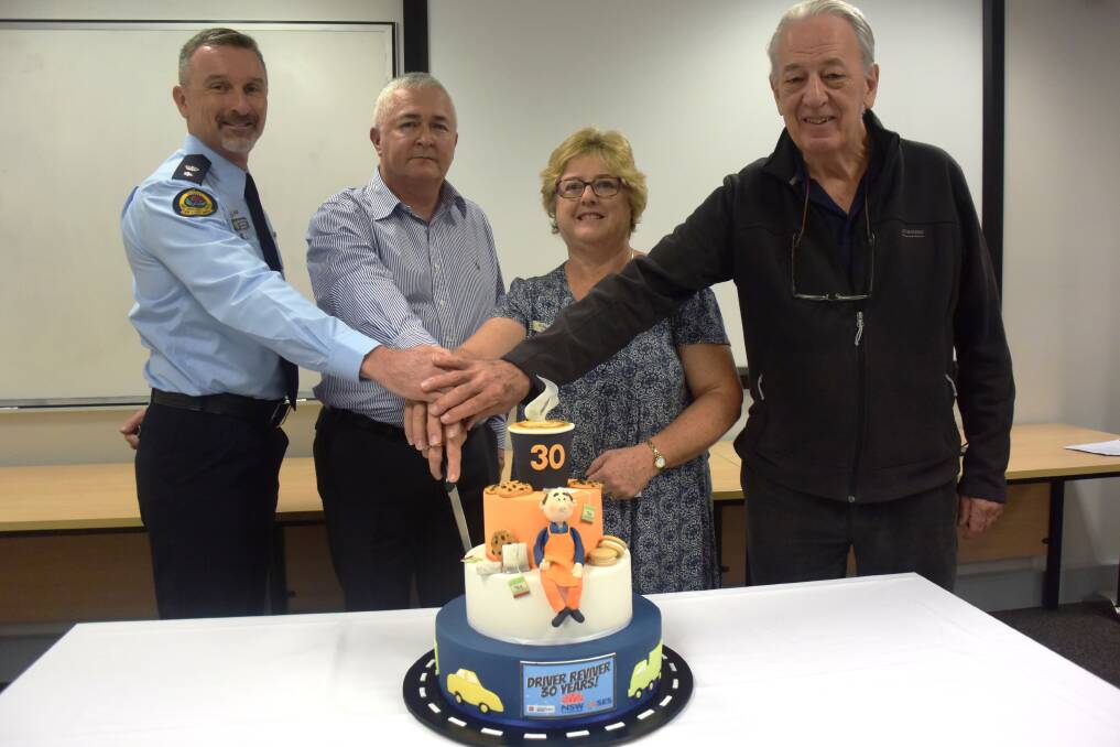 End of an era: SES northern zone deputy commander Anthony Day, Sergeant Paul Dilley, Susan Schmitzer and Robert Toms cut a cake to mark 30 years of the Hastings Driver Reviver. 