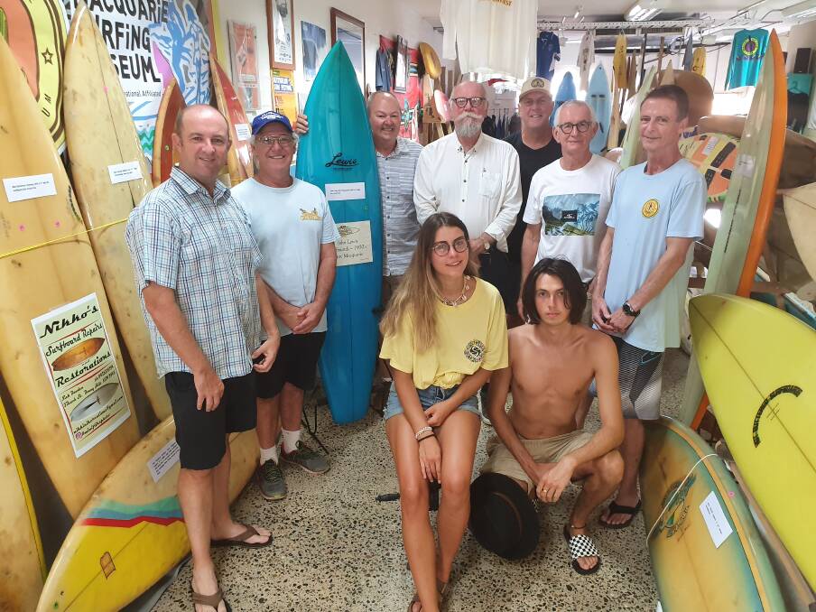 Wave of support: Surfing history museum supporters Paul Dawson, Joe Doust, Adam Roh, Glenn Dick, Jim Cain, Steve O'Connor, Dave Ridding and (front) French tourists Lelia Leclerc and Benjamin Bremond appreciate the surfing culture.