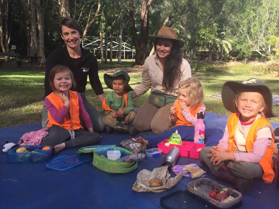 Leading the way: (back) Educator Julie-anne Thompson, program manager Jacqui Leach and (front) The Nature School's early years program participants Evie Judd, Aiden Robinson, Aurora McDonald and Grace Stephens enjoy lunch in the great outdoors.