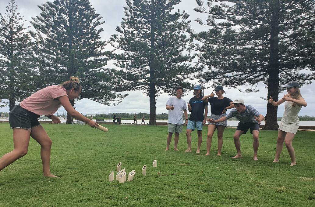 Holiday fun: Holidaymaker Nicola Blatchford plays the popular log-tossing game, Finska, with support from Charlie Bredman, Declan Owens, Jacqui Bloomfield, Dave Forit and Jess Nutt.