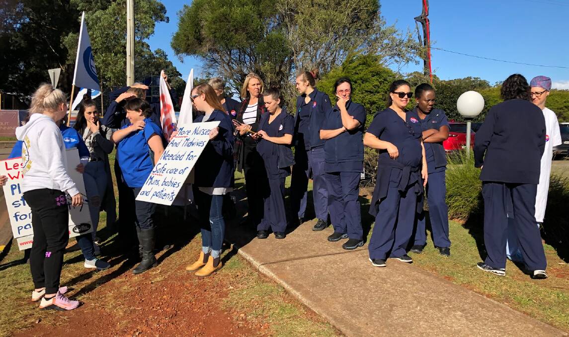 Making a statement: NSW Nurses and Midwives' Association Port Macquarie Base Hospital Branch members gather outside the hospital grounds during the two-hour stop work meeting. Photo: NSW Nurses and Midwives' Association Port Macquarie Base Hospital Branch